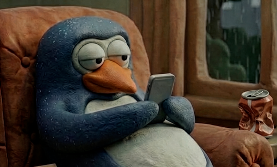 Penguin looking at phone in sofa
