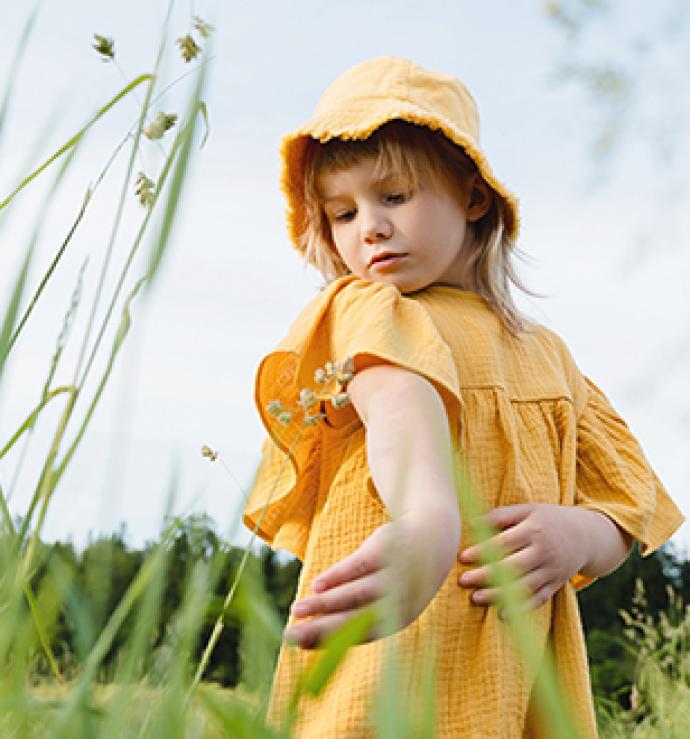Girl checking her arm in the fields