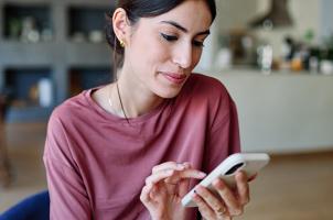 Woman interacting with smartphone