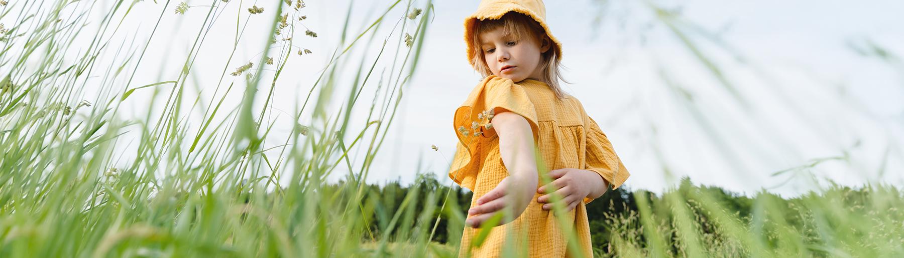 Girl checking her arm in the fields