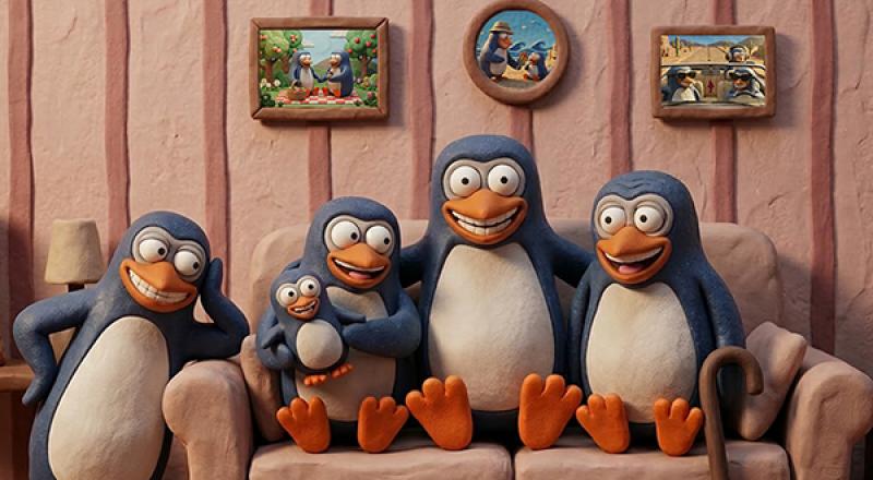Penguins smiling in sofa