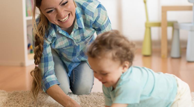 woman playing with baby