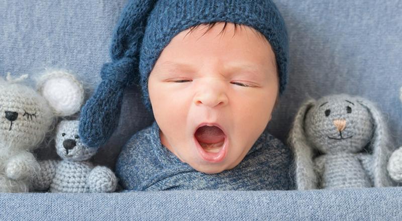 baby sleeping with plushes