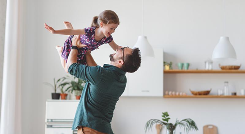 dad holding daughter